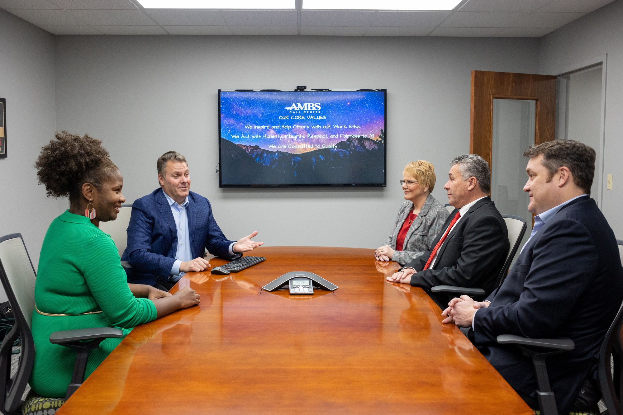 Ambs Call Center Leadership Team sitting around Conference Room Table