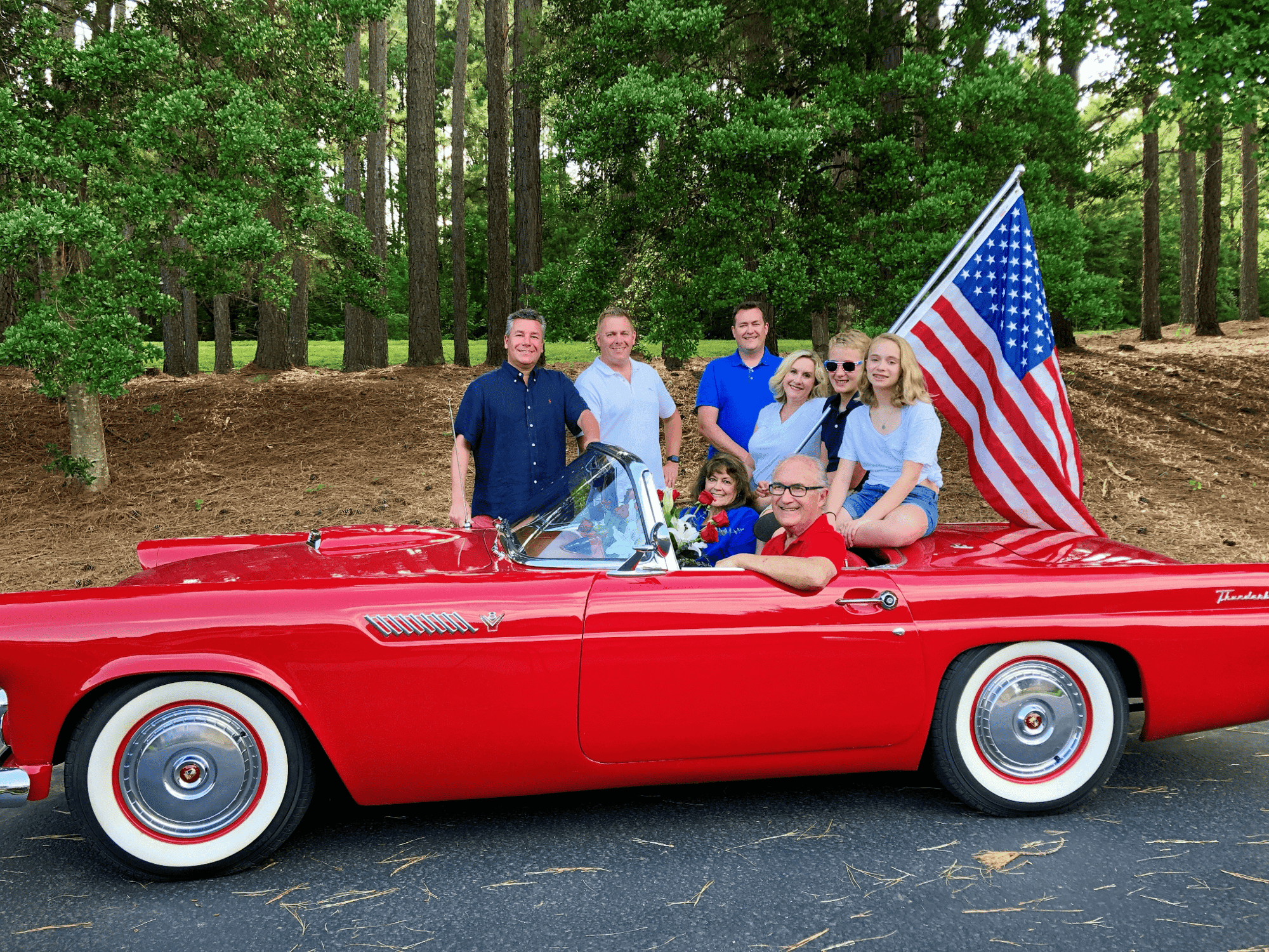 ambs family standing together around a car
