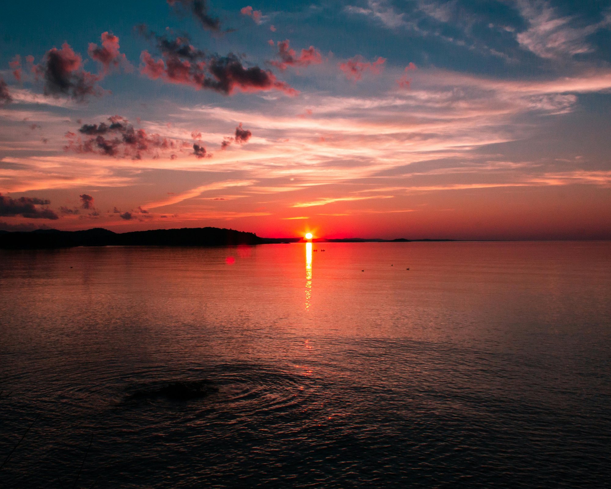 sunset on water in marquette michigan