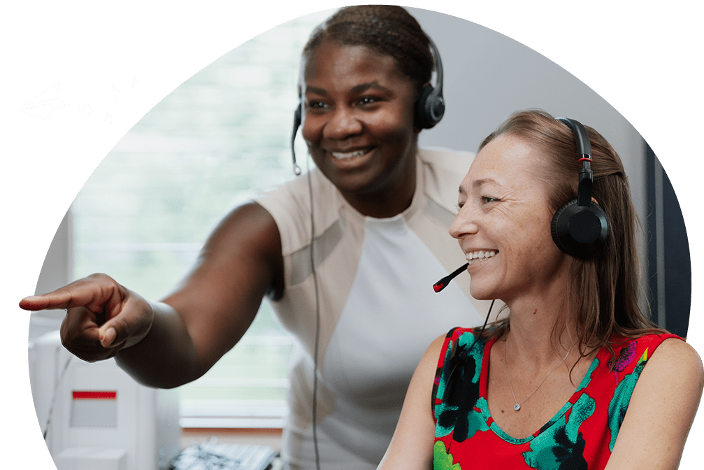 two answering service and call center agents for ambs call center smiling and looking right while on call with a customer