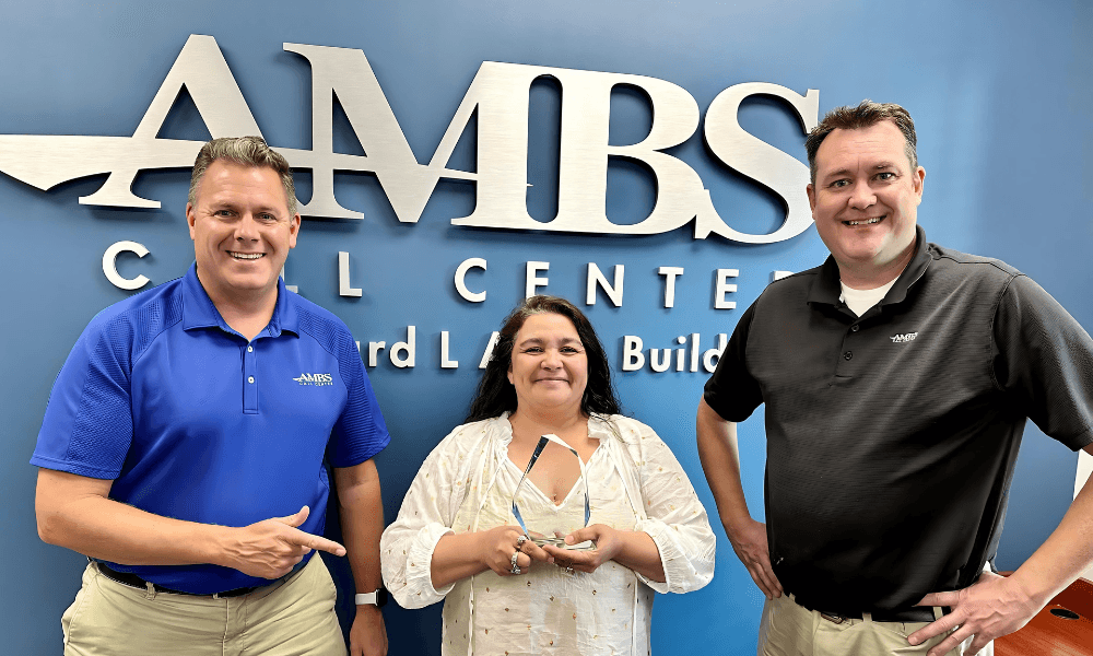 Ambs Call Center smiling team holding ATSI award of excellence